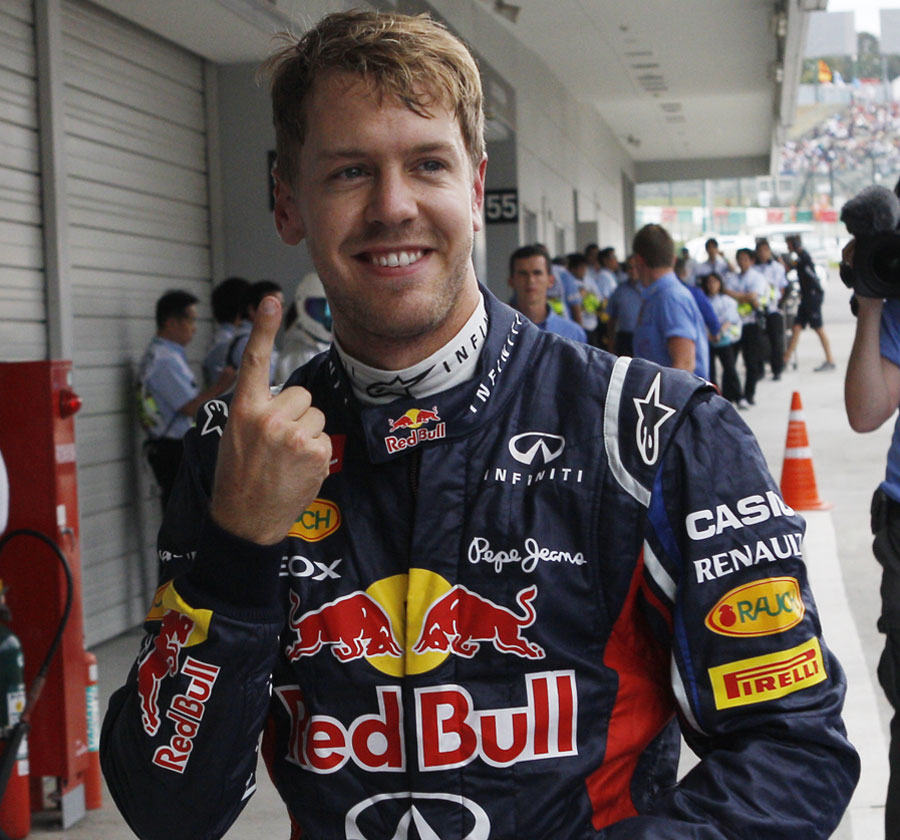 Sebastian Vettel celebrates pole position in his customary style