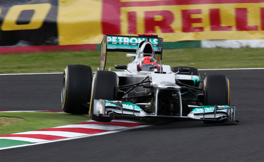 Michael Schumacher jumps his Mercedes over the kerbs