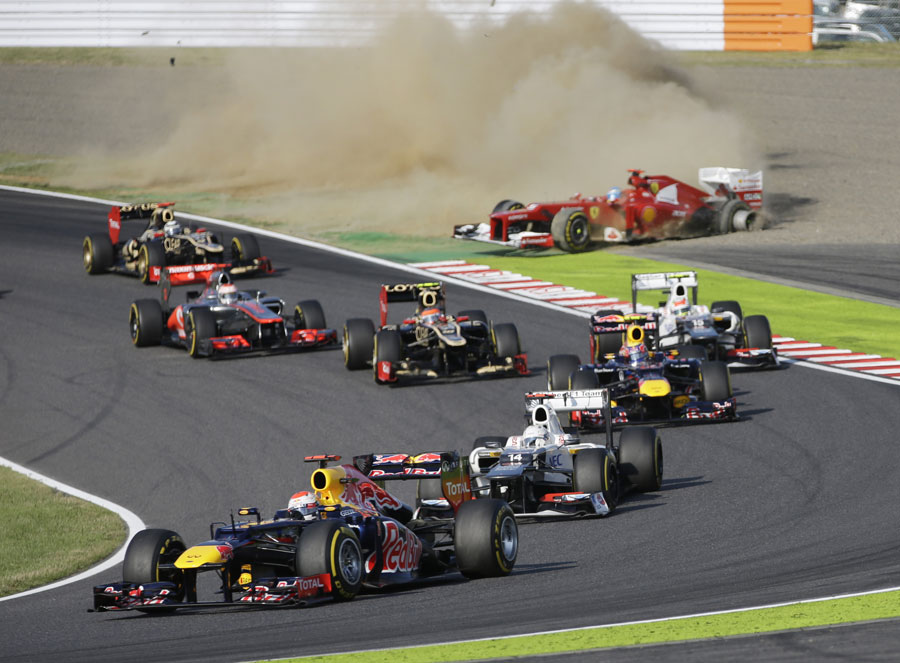 Sebastian Vettel leads as Fernando Alonso retires in the background at the start of the race