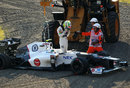 Sergio Perez climbs out of his Sauber after spinning off at the haripin