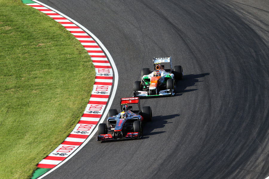 Nico Hulkenberg follows Lewis Hamilton through turn one