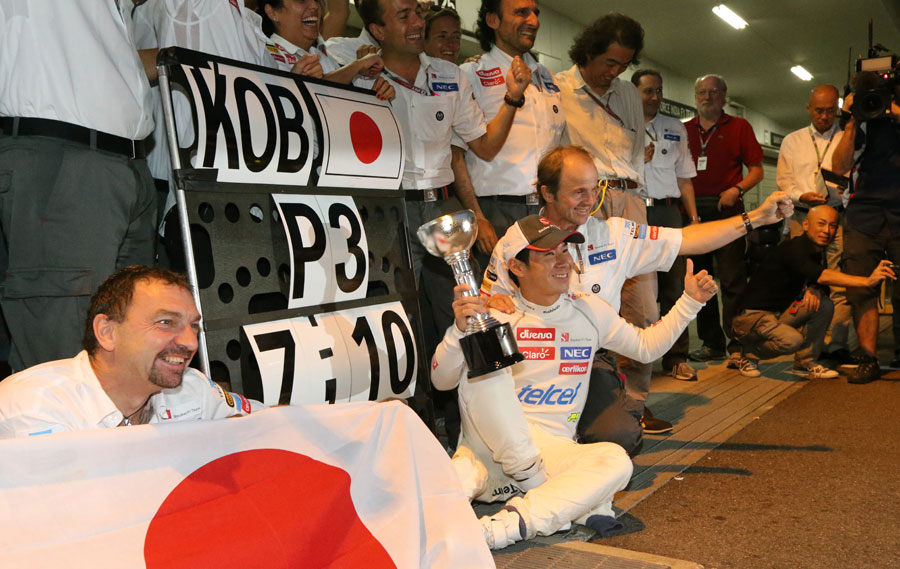 Kamui Kobayashi celebrates his maiden podium with his team