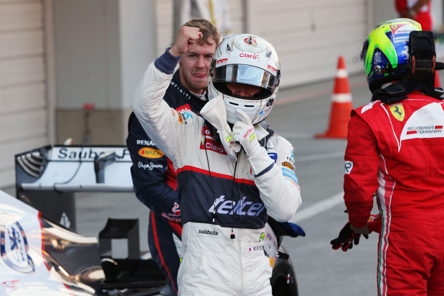 Kamui Kobayashi celebrates his maiden podium in parc ferme