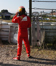 Fernando Alonso watches on from the side of the track after spinning out at turn one