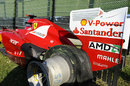 Fernando Alonso's Ferrari on the outside of turn one after he retired with a puncture