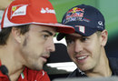 Sebastian Vettel and Fernando Alonso chat during the driver press conference