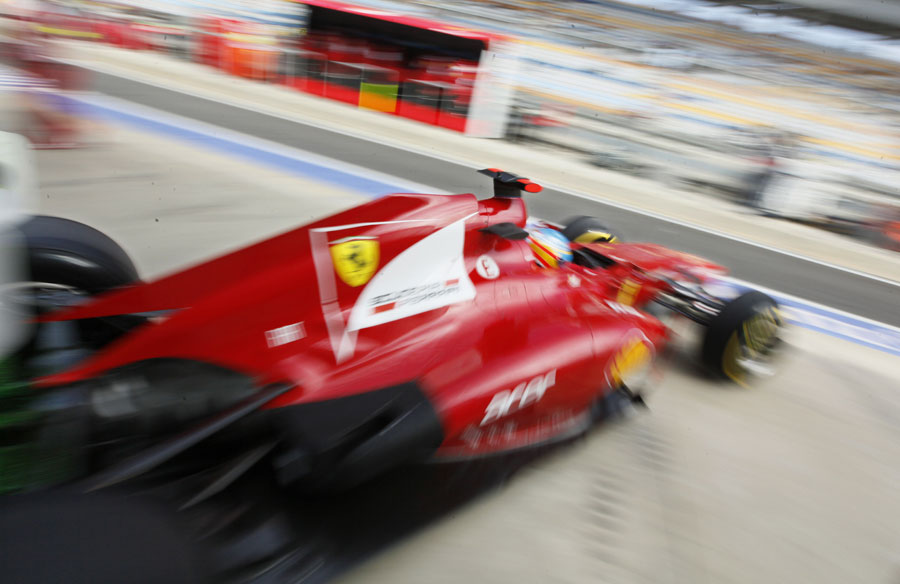 Fernando Alonso leaves the Ferrari garage