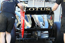Lotus mechanics wheel the updated E20 through the pit lane