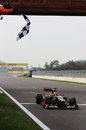 Romain Grosjean takes the chequered flag at the end of qualifying