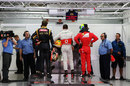 Romain Grosjean, Lewis Hamilton and Felipe Massa wait to be weighed