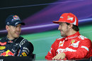 Sebastian Vettel and Fernando Alonso chat in the post race press conference