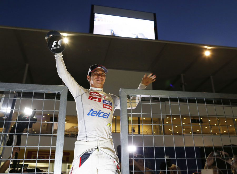 Kamui Kobayashi celebrates his maiden podium on the pit wall