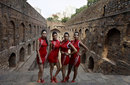 Grid girls pose during a photoshoot to promote the Indian Grand Prix