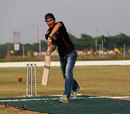 Mark Webber shows off his batting skills while facing the bowling of cricketer Gautam Gambhir
