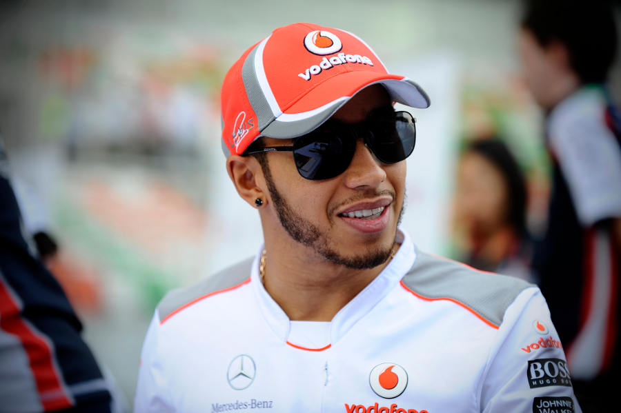 Lewis Hamilton smiles during an autograph signing session