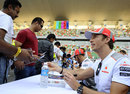 Jenson Button signs autographs for fans