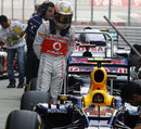 Lewis Hamilton takes a closer look at Mark Webber's Red Bull