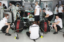 Mercedes mechanics work on Nico Rosberg's car