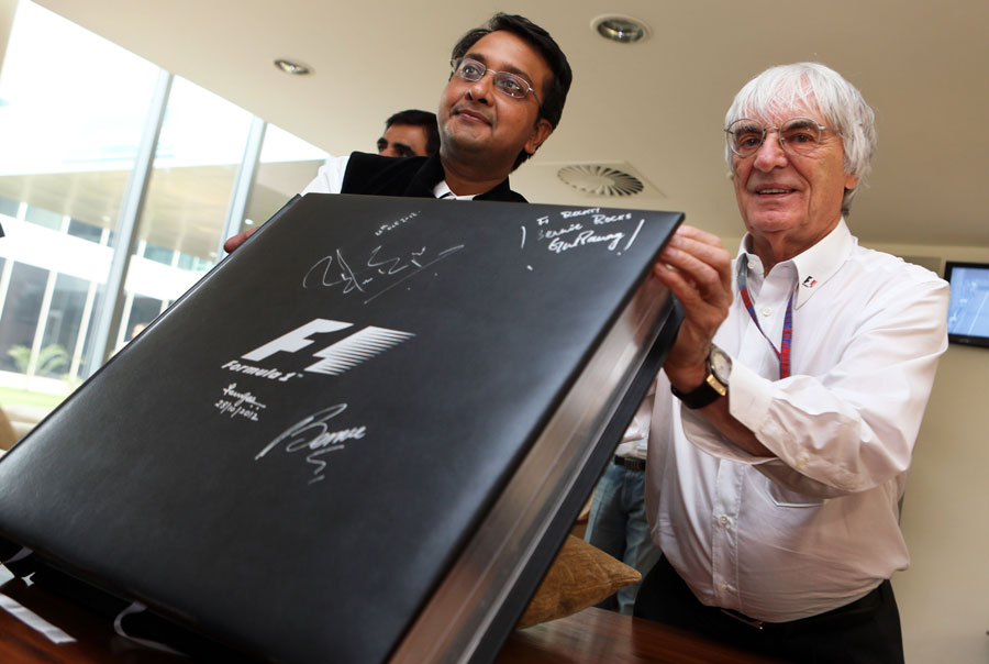 Bernie Ecclestone receives a large photo book on Formula One history as a present for his 82nd birthday
