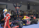 Sebastian Vettel celebrates his victory in parc ferme as Fernando Alonso walks by