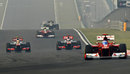 Lewis Hamilton and Jenson Button battle for position as Fernando Alonso chases down the Red Bulls