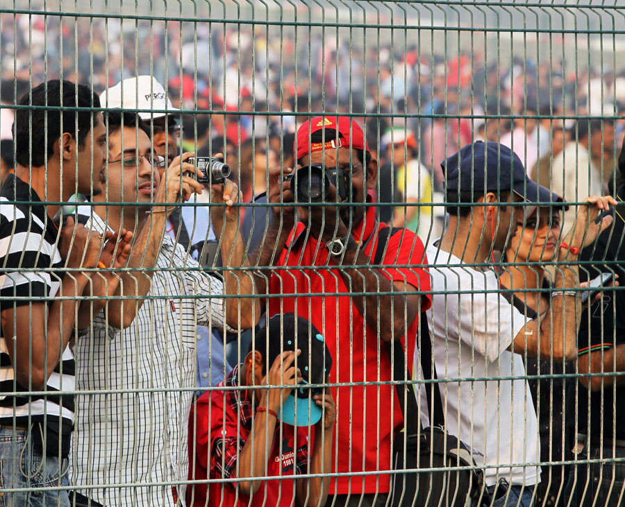 Fans press up to the fence to get a better view