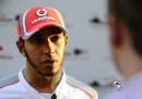 Lewis Hamilton talks to the press in the paddock
