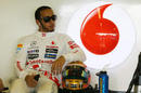 Lewis Hamilton waits in the McLaren garage during first practice