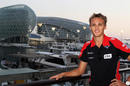 Max Chilton poses in front of the Yas Hotel