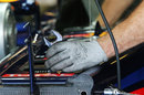A mechanic makes adjustments to Mark Webber's Red Bull
