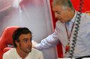 Fernando Alonso talks to Piero Ferrari, son of Enzo, at the back of the garage