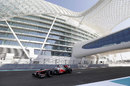 Jenson Button passes under the Yas Hotel during FP1