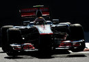 Lewis Hamilton skips over the kerbs in his McLaren 