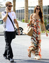 Jenson Button arrives in the paddock with Jessica Michibata