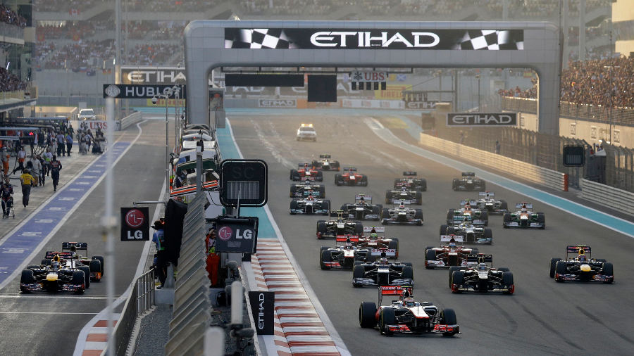 Lewis Hamilton leads away as Sebastian Vettel waits in the pit lane