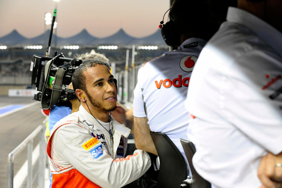 Lewis Hamilton on the McLaren pit wall after his retirement