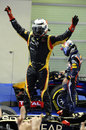 Kimi Raikkonen celebrates on top of his Lotus