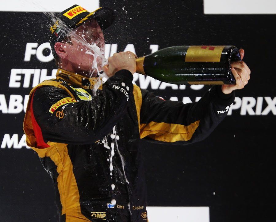 Kimi Raikkonen celebrates in traditional style on the podium
