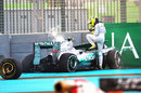 Nico Rosberg climbs out of his wrecked Mercedes