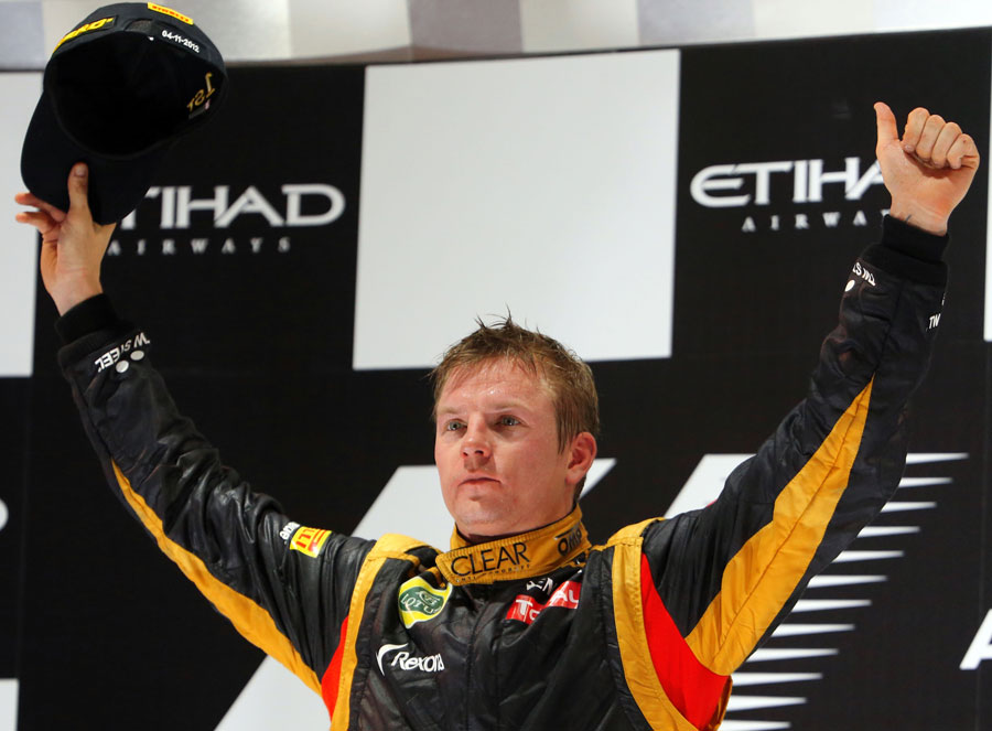 Kimi Raikkonen celebrates victory on the podium