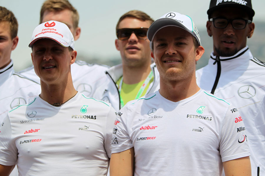 Michael Schumacher and Nico Rosberg pose for a photo 