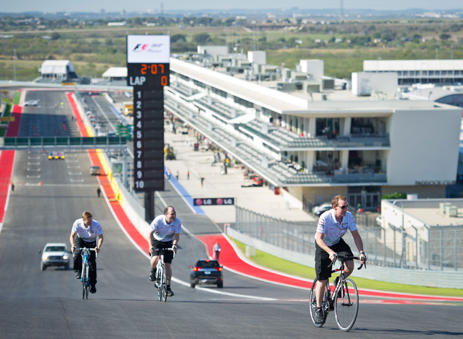 Cyclists climb up the hill to the first corner of the Circuit of The Americas
