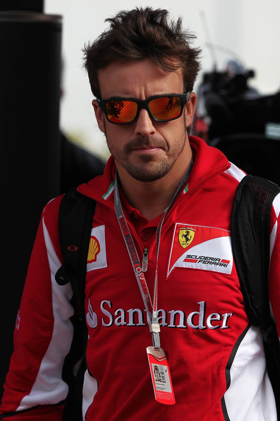 Fernando Alonso walks through the paddock 