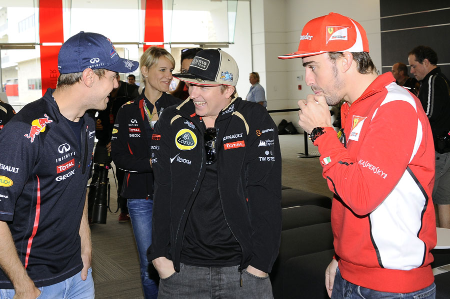 Sebastian Vettel, Kimi Raikkonen and Fernando Alonso joke outside the media centre