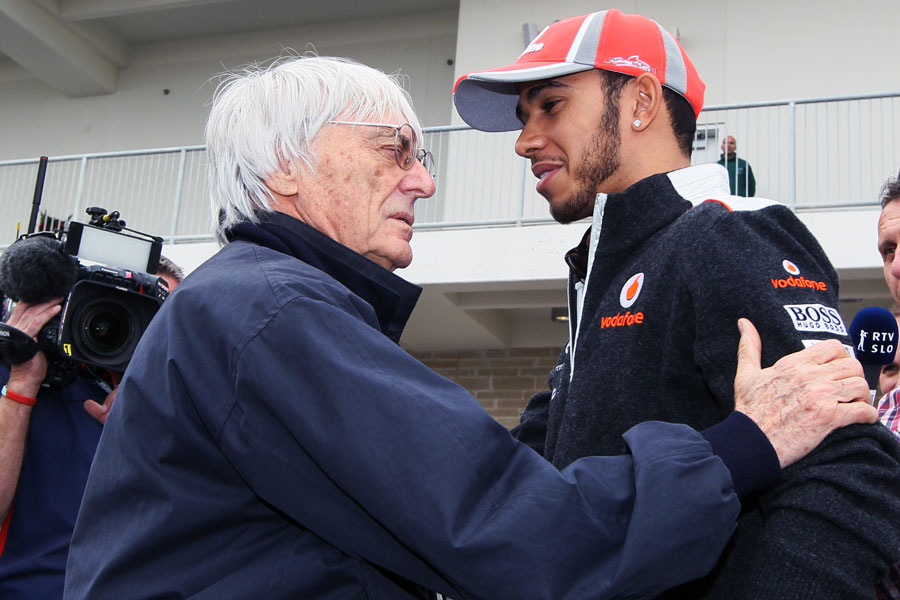 Lewis Hamilton and Bernie Ecclestone chat in the paddock