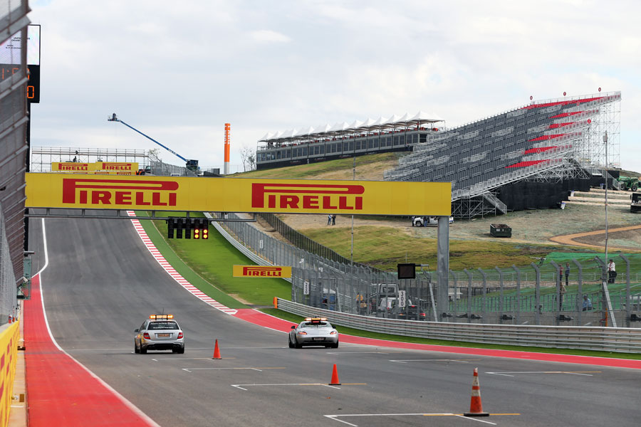 The medical car and safety car race towards turn one