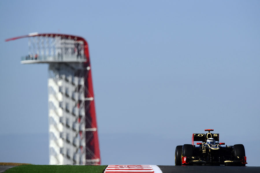Kimi Raikkonen crests a hill with the observation tower in the backgrdound
