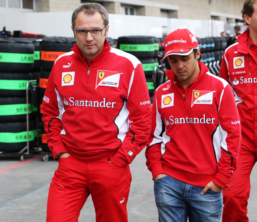 Stefano Domenicali and Felipe Massa walk through the paddock