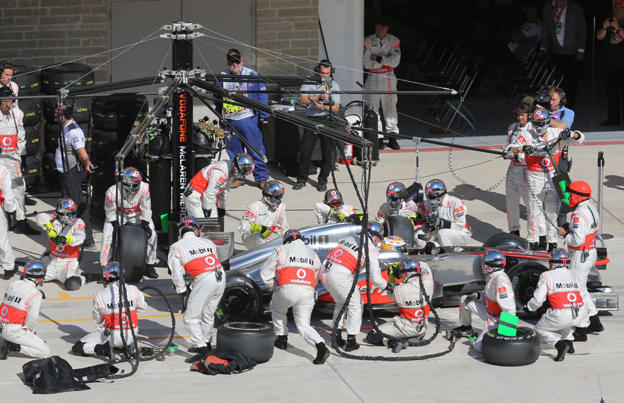 The McLaren team in action during a pit stop
