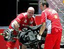 Crew members from the Ferrari team unpack on arrival at Interlagos
